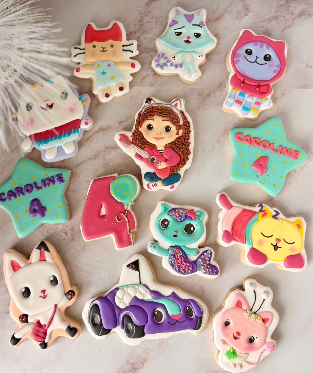 Colorful character cookies for a fourth birthday